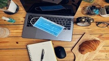 laptop, notepad, and desk accessories