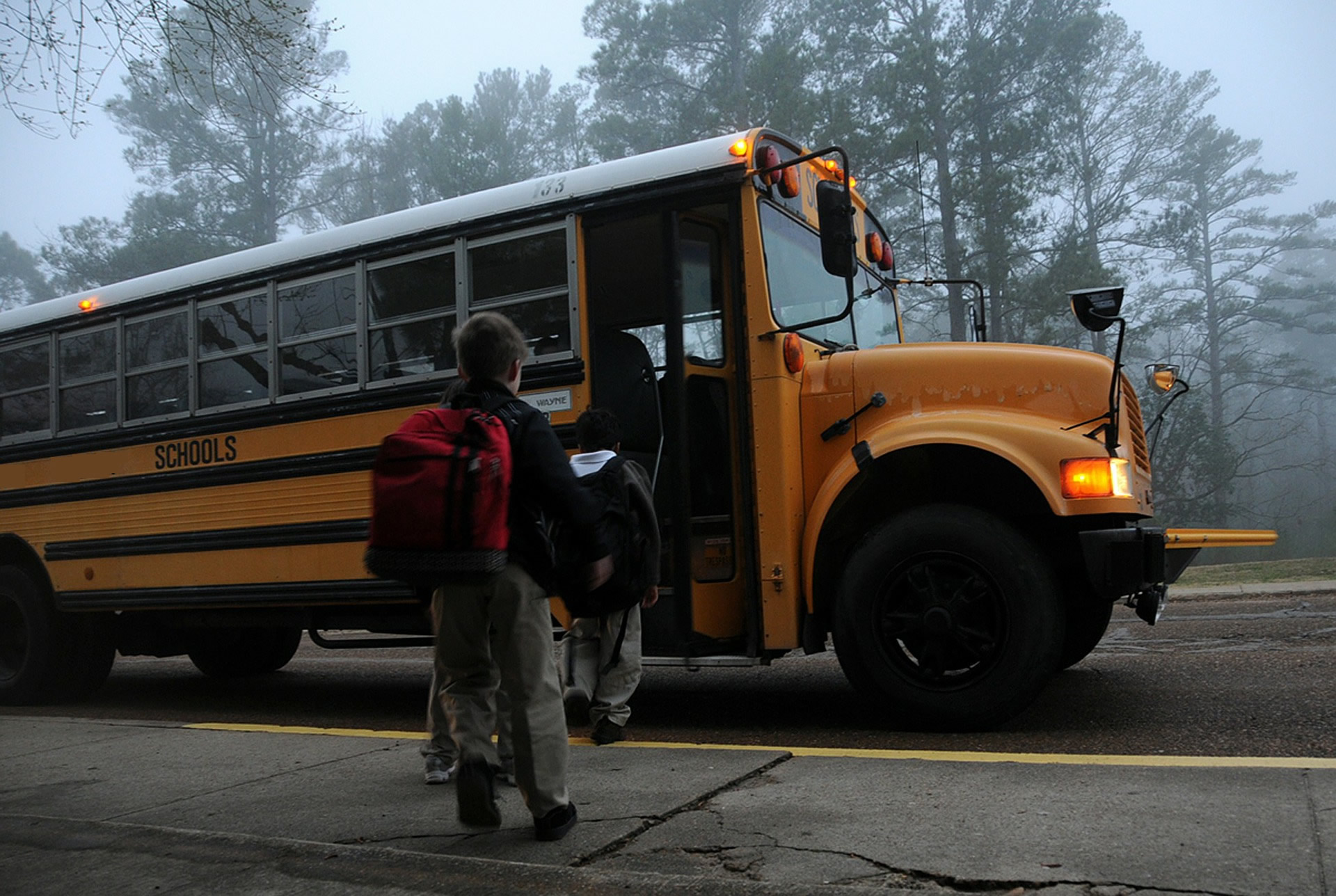 students boarding school bus